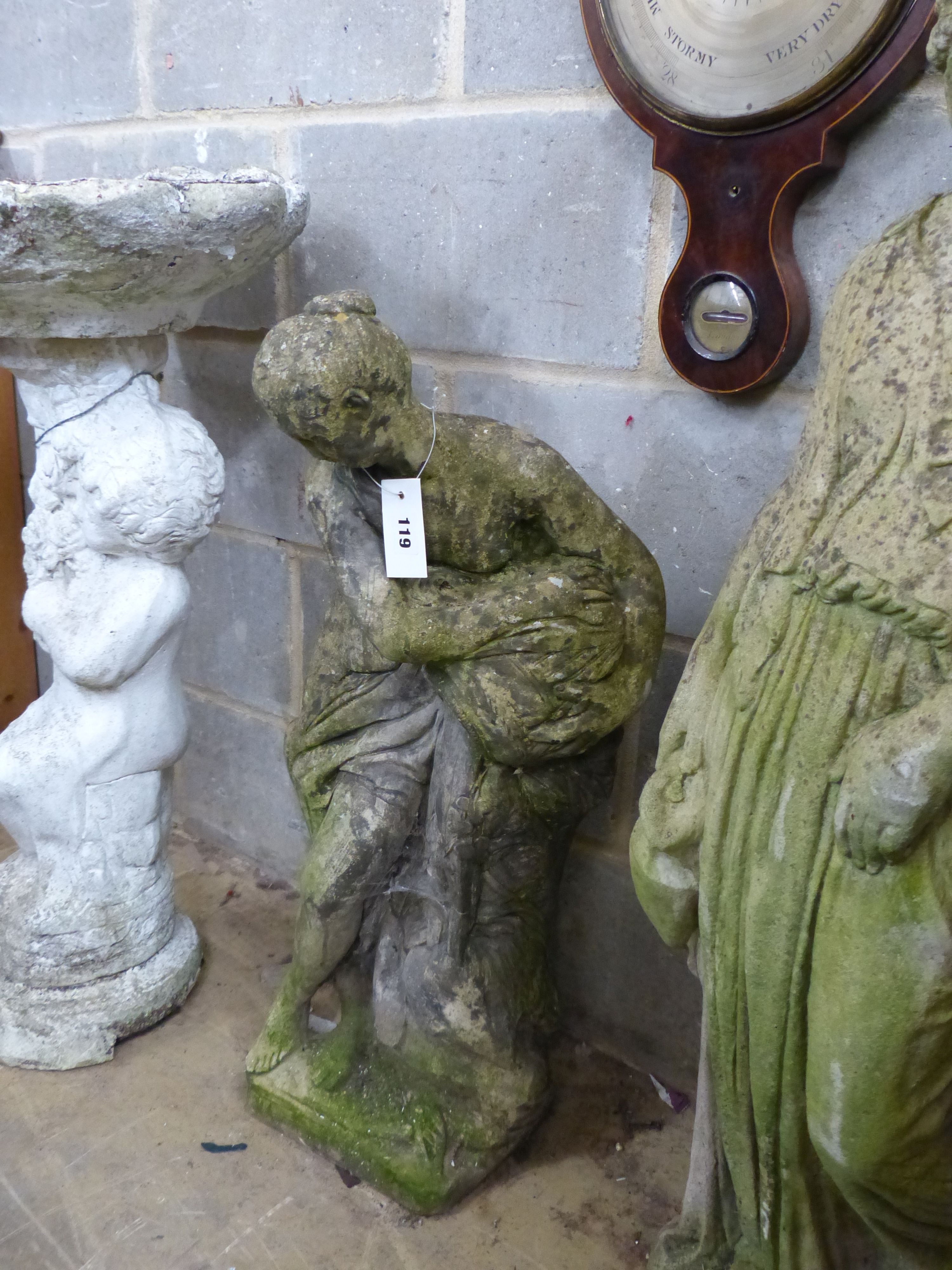 Two reconstituted stone garden statues and a bird bath, largest height 99cm